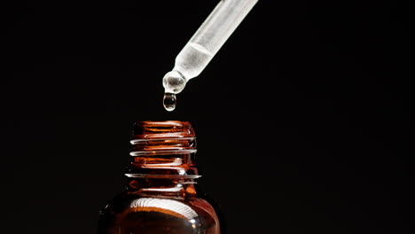 dropper filling amber bottle