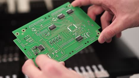 person holding a circuit board