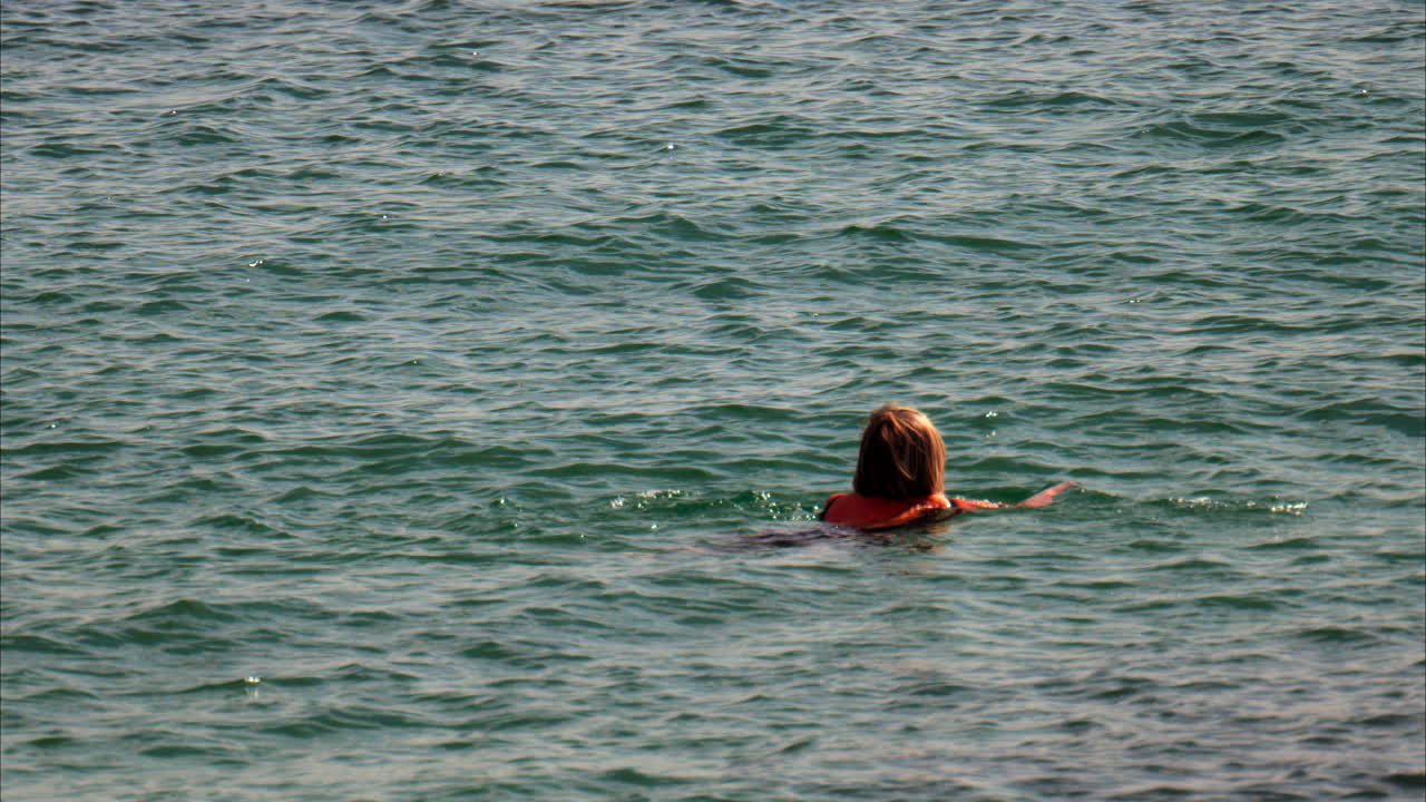 View of a woman swimming in the sea in Antibes, France, on a sunny day