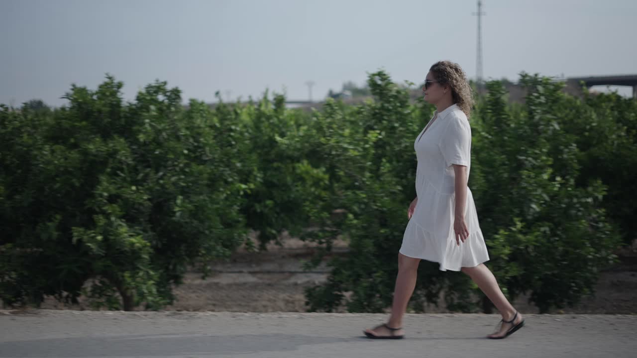 Woman walking in an orchard