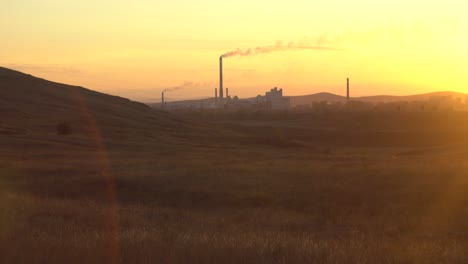 sunset over industrial landscape