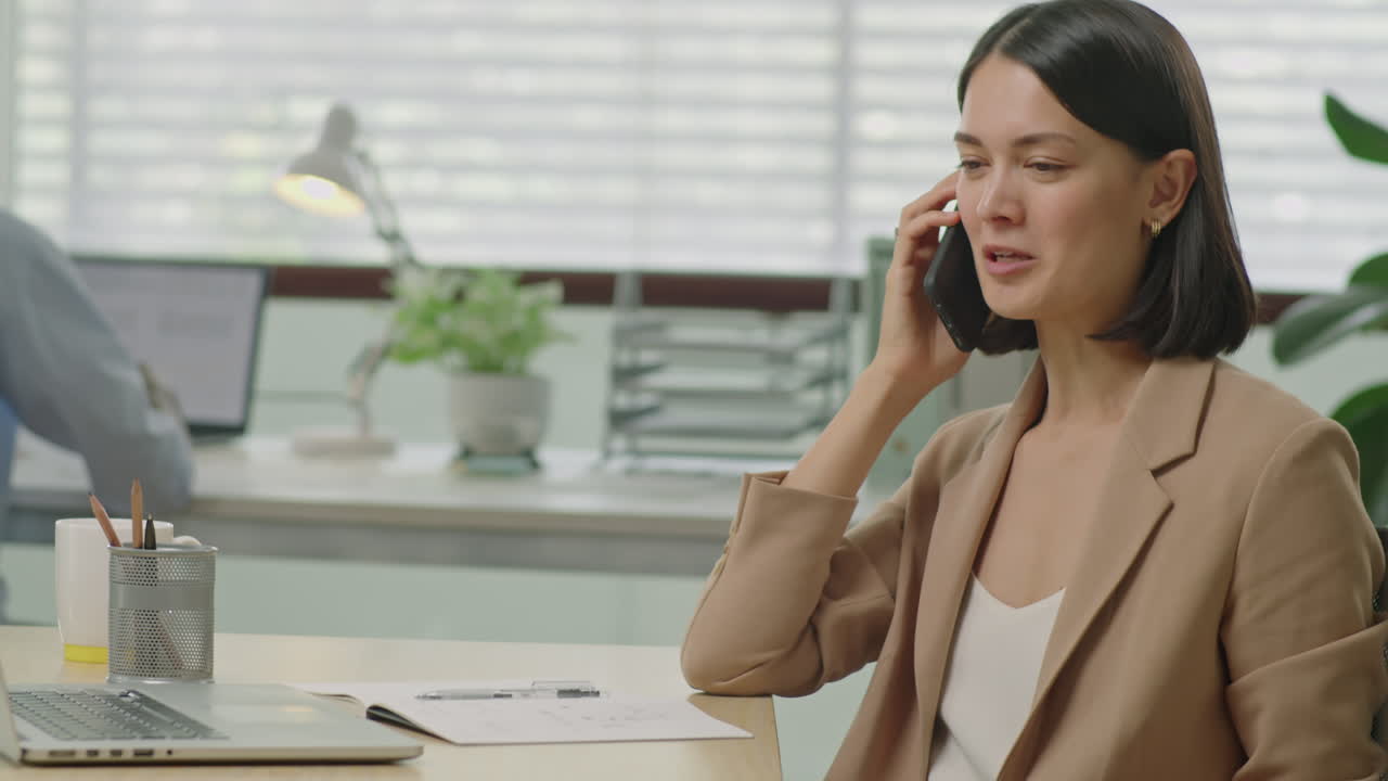Businesswoman Having Phone Call in Office