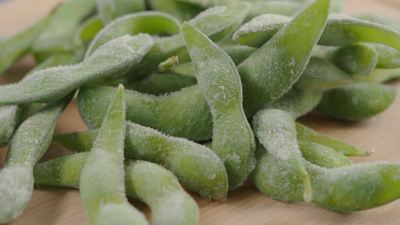Close Up of Frozen Edamame Pods on a Wooden Board