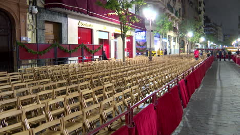 nighttime street event with rows of chairs