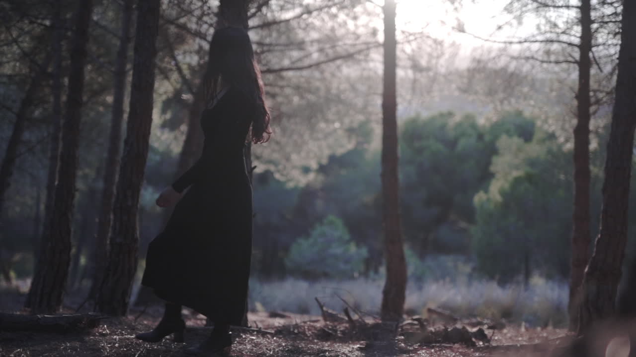 Witch lady in black haunting woods in Spain