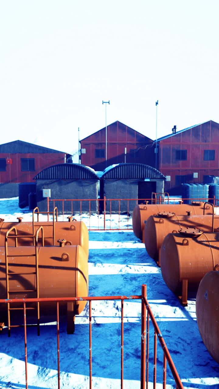 Remote research facility surrounded by snow covered mountains in a remote area