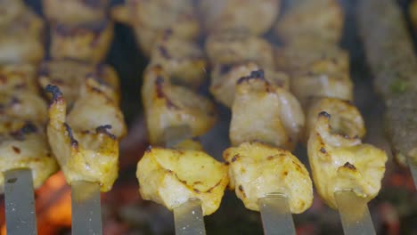 macro shot of chicken tawouk in skewer grilled over charcoal with smoke