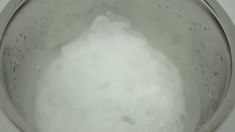 dry ice at the bottom of a stainless steel bowl