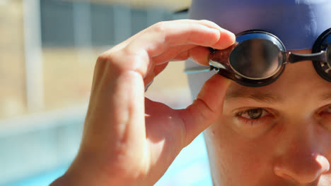 Male-swimmer-standing-near-pool-side-4k