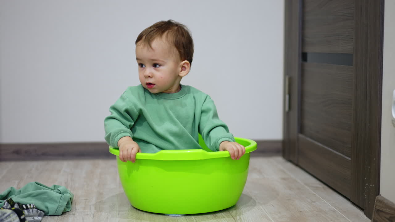 Baby Playing in a Green Plastic Basin