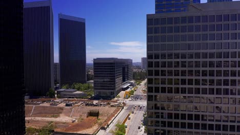 Aerial-descending-shot-flying-through-the-skyscrapers-in-Century-City,-California