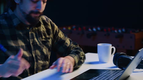 entrepreneur working from home, using laptop and writing notes on paper