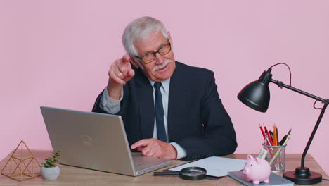 Senior-businessman-smiling-pointing-to-camera,-choosing-lucky-winner,-indicating-to-awesome-you