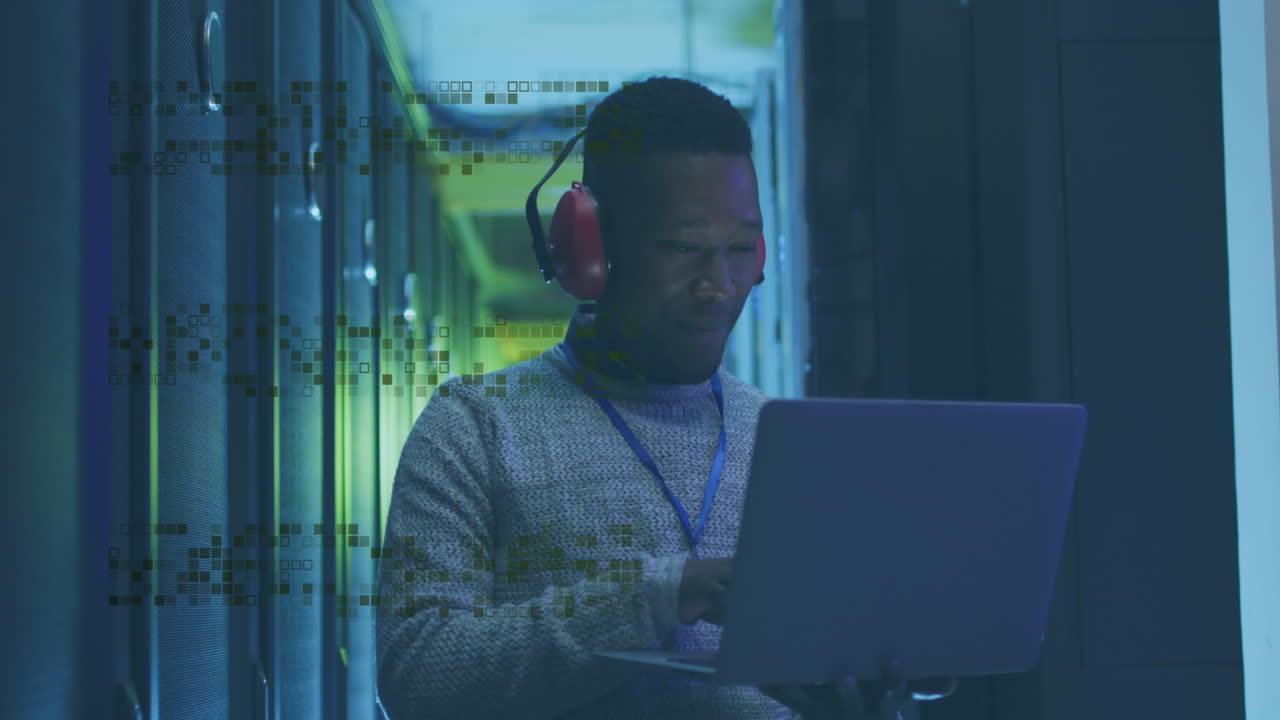 Animation of shapes over african american male worker in server room