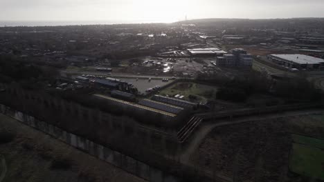 aerial overview of city and industrial area - tilt up shot and dolly in shot
