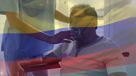 Animation-of-flag-of-colombia-over-diverse-doctor-and-patient-wearing-oxygen-mask