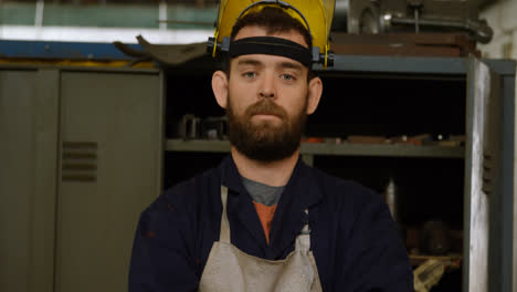 metalsmith standing with arms crossed in workshop 4k