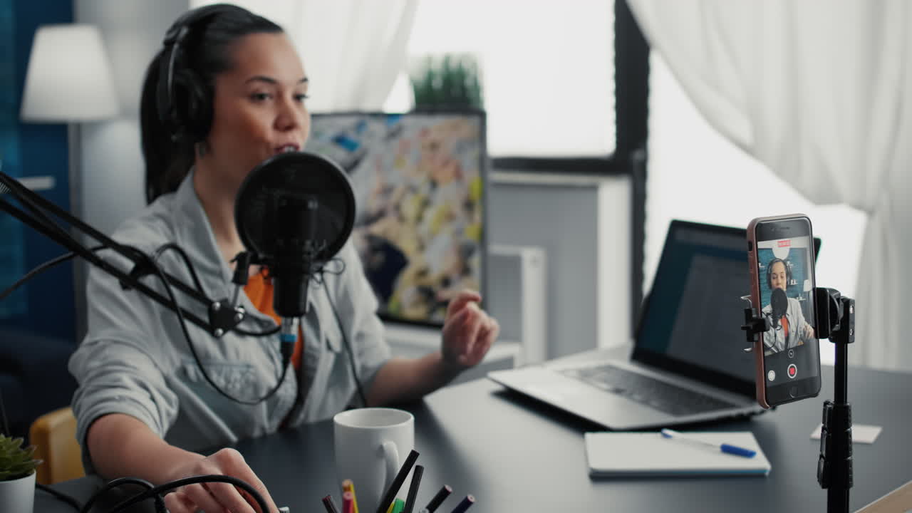 Smiling content creator starting to record vlog while putting on headphones