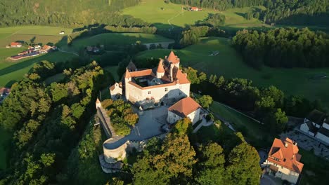 orbit drone shot at sunset right above gruyeres castle in canton of fribourg in switzerland.