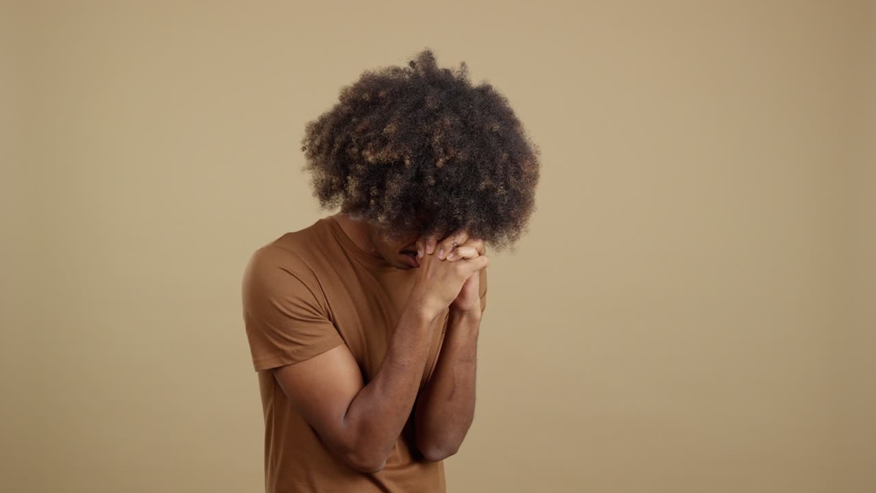 Man with Afro Engaged in Prayer and Contemplation