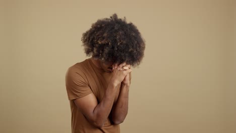 man with afro engaged in prayer and contemplation