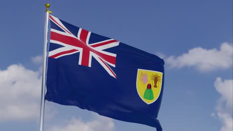 flag of the turks and caicos islands moving in the wind with a clear blue sky in the background, clouds slowly moving, flagpole, slow motion