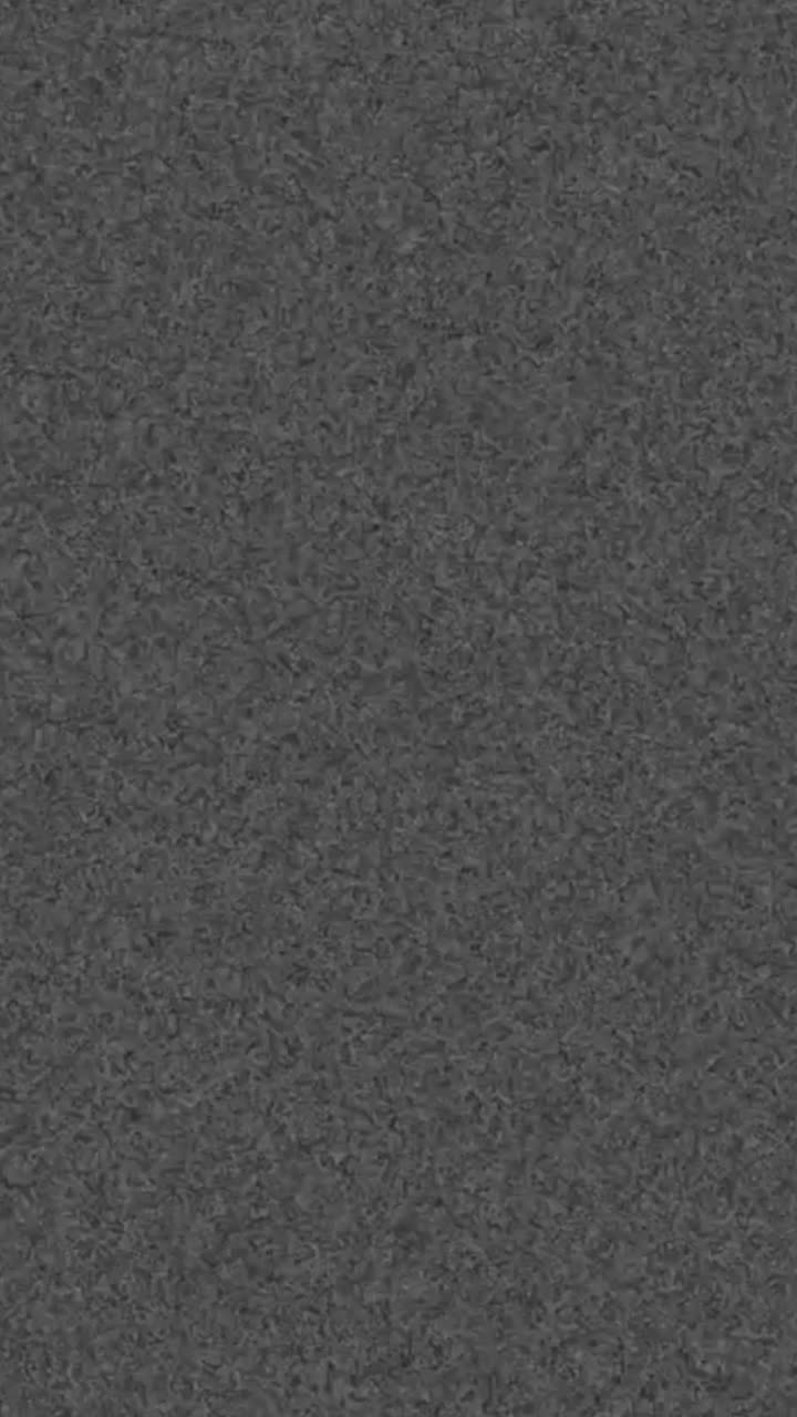 Textura granulada gris oscuro desvaneciéndose a pantalla negra