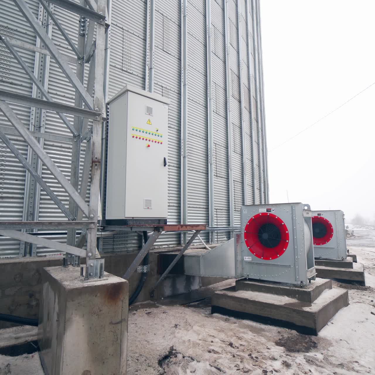 Big factory cistern exterior construction. Huge modern elevator premises with big ventilators. Circle view with approximation to a locker with buttons