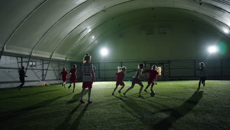 young girls soccer team playing indoor soccer