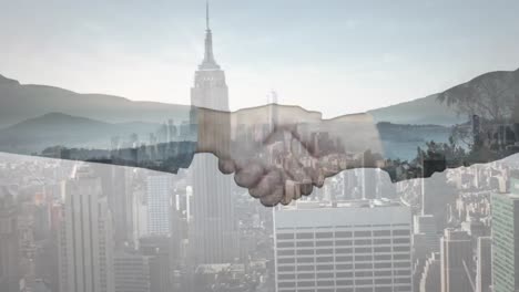 composite video of businessman and businesswoman shaking hands against aerial view of cityscape