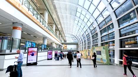 travelers walking through a modern airport terminal