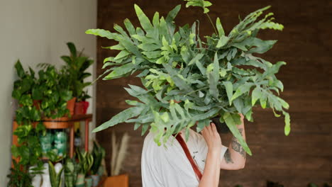 woman surrounded by plants in a plant shop