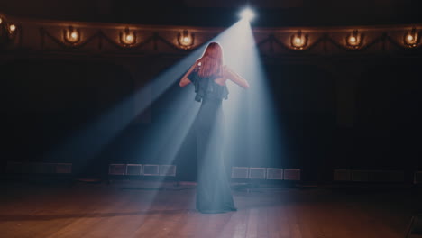 young actress speaking passionately on stage young woman in elegant dress gesticulating and talking passionately with audience then walking away in end of performance in theater