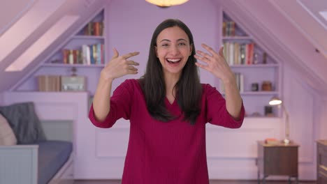 Happy-Indian-woman-pointing-and-calling-someone