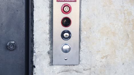 extreme close up of hand pressing button to call elevator