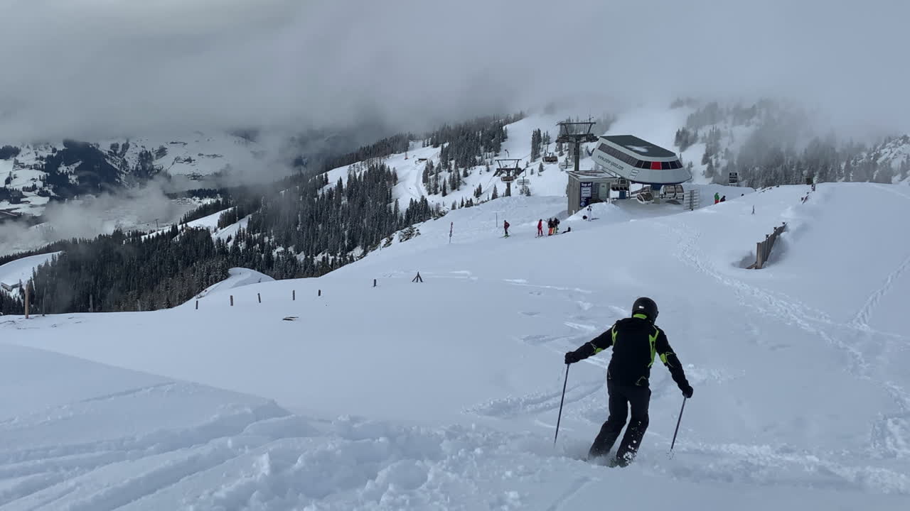 A Skier Skiing On The Downhill And Leaving A Track On The White Snow - Ski Resort In Austria During Winter