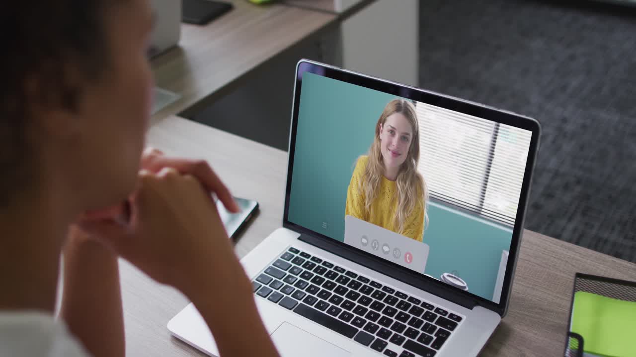 African american woman having a video call on laptop with female colleague at office