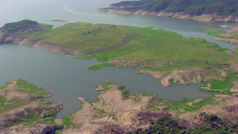 Aerial-view-over-the-small-Ireland-with-green-grass,-land-and-trees