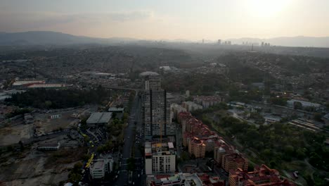 backwards-drone-shot-of-western-Mexico-city-and-huge-residential-buildings