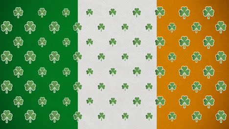 animación digital de varias hojas de trébol que se mueven contra la bandera irlandesa