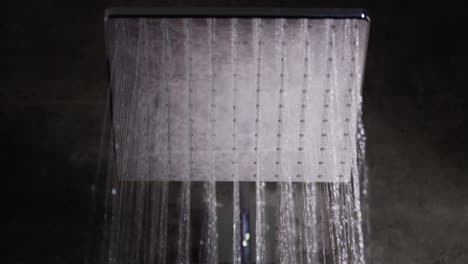 jets of water flow from the square shower head. elite plumbing and comfort, slow motion video