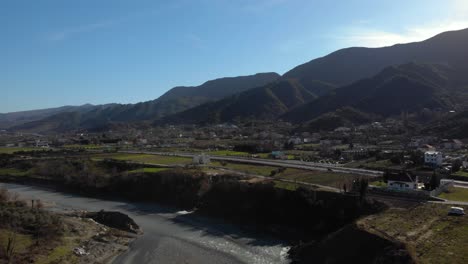 Carretera-Junto-Al-Río-Y-Las-Montañas,-Día-Soleado-De-Invierno-En-El-Paisaje-Albanés