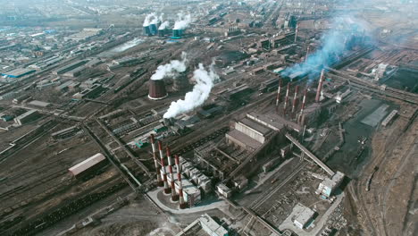 aerial view of industrial zone with factories expelling smoke around a green landscape 2