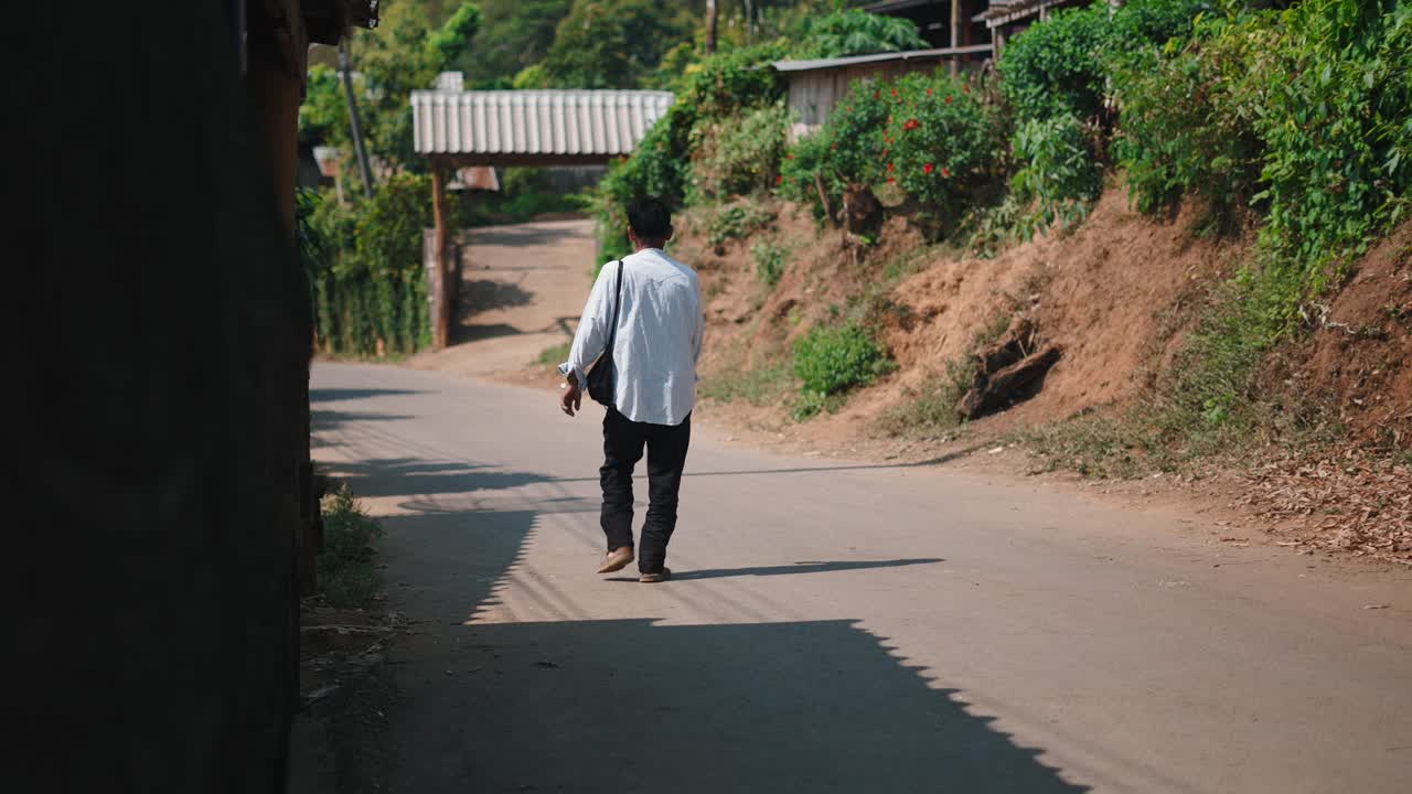A man walking down a village street