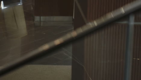 top view of a woman in elegant clothes and heels entering the hotel carrying suitcases and a coffee