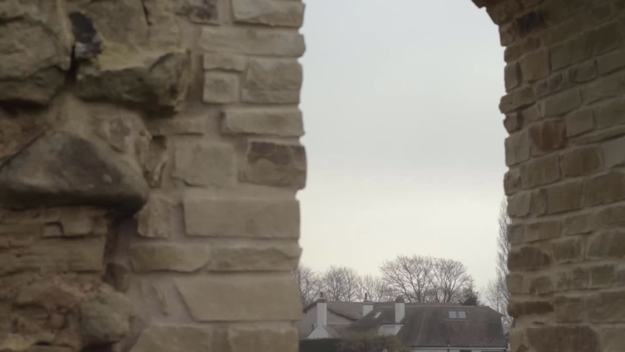 View through castle ruins archway stone structure