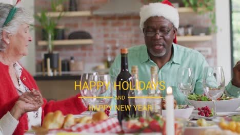 animation of christmas greetings text over diverse friends at christmas meal table