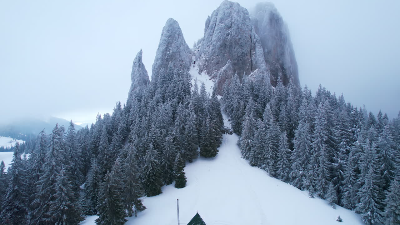 Snowy Mountain Landscape with Cabin and Rock Formations