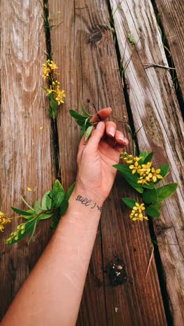 hand with tattoo and flowers on wooden planks