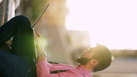 young man engrossed in his laptop outdoors